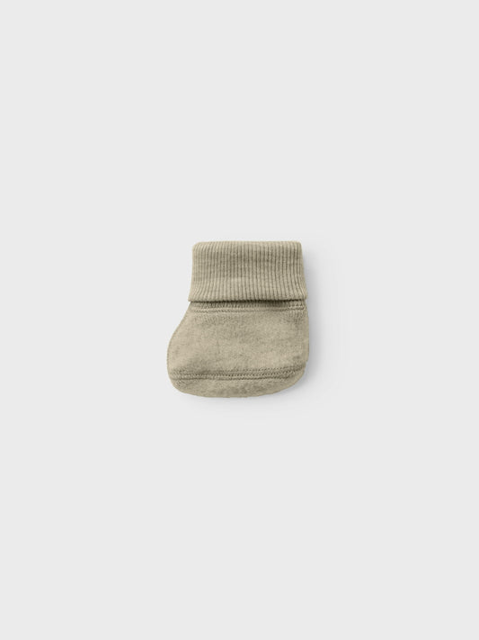 Söta ull tossor till din lilla baby pojke och flicka. Se till att ni har mjuka och mysiga ullkläder i din bebis garderob och säkerställ komfort året runt.
Detaljtyp: Tofflor
Ull är ett naturligt material känt för sina termiska egenskaper, mjukhet och fluffiga utseende. I kallt väder håller ull värmen och under varma dagar absorberar den svett, vilket gör den till ett bra val oavsett årstid. Ull låter huden andas och bevarar sin förmåga att isolera när den är våt, och bibehåller alltid en stabil krop