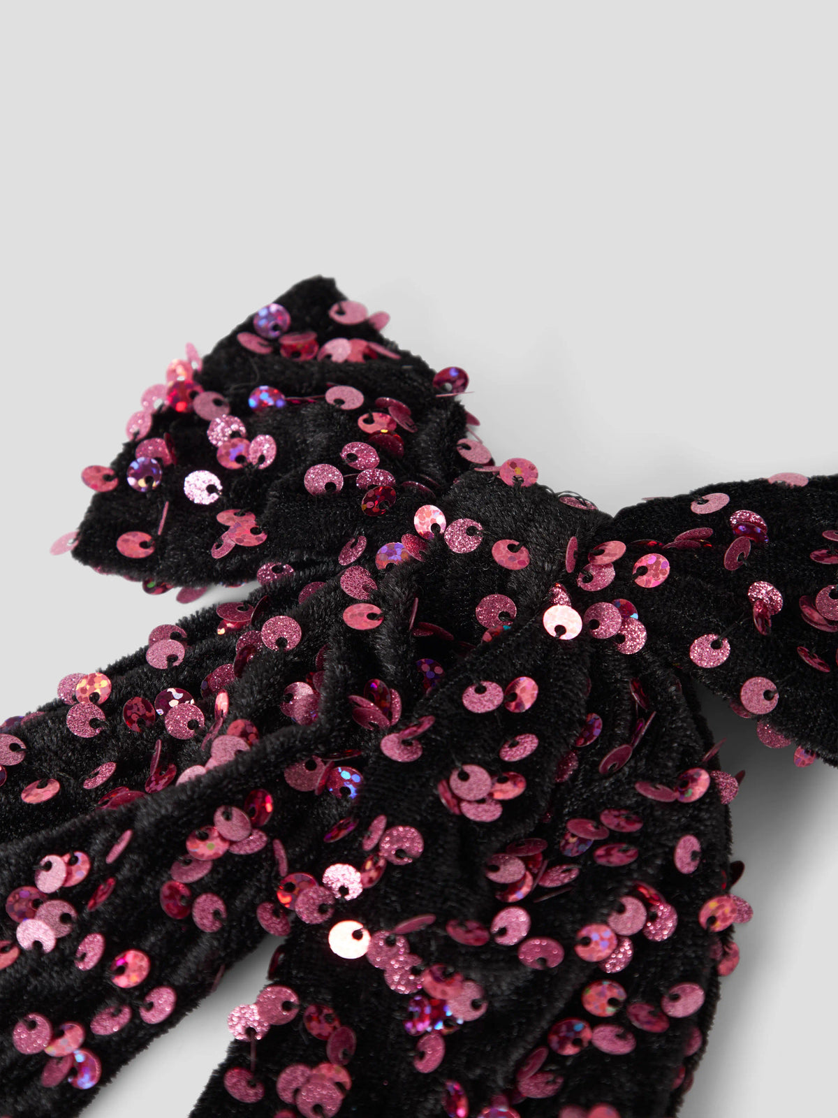 Runica hårrosett i svart velour med rosa och vinröda paljetter
