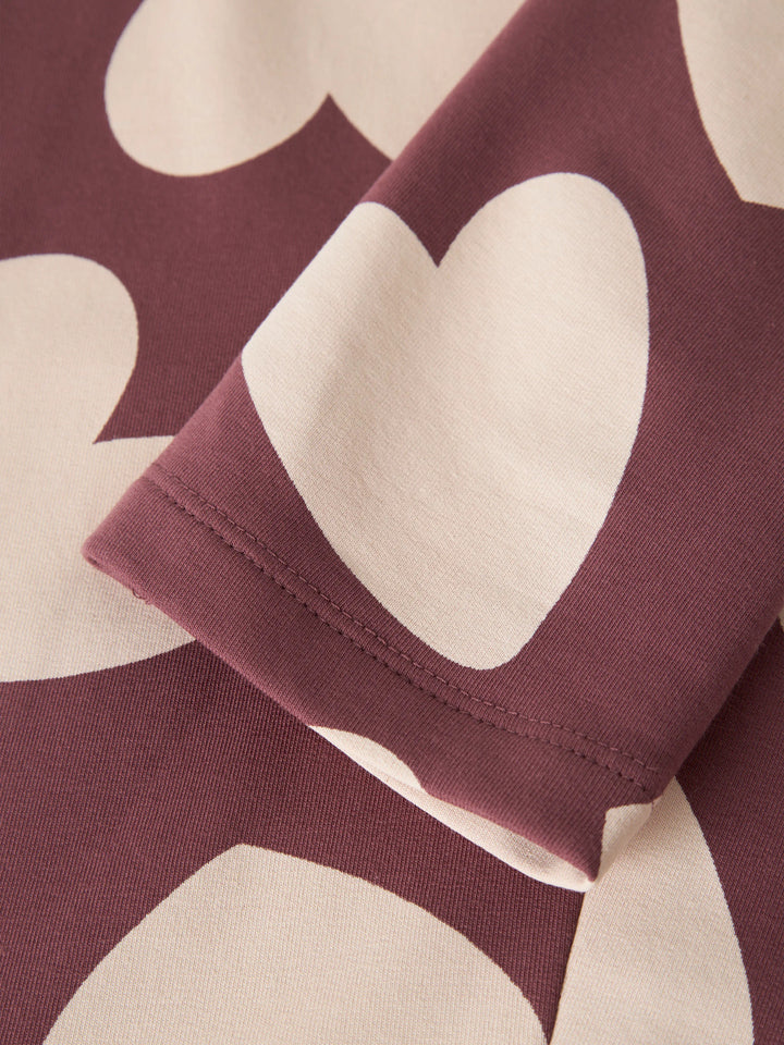Name It Davina sweatleggings till flicka i färgen Wild Ginger med stora vita hjärtan.