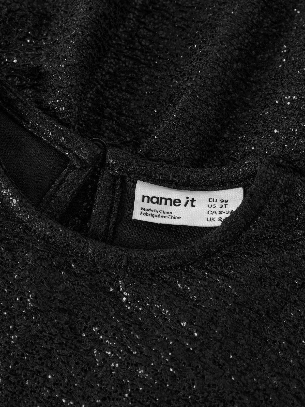 Name It Risine glittrig svart klänning med lång ärm för flicka framifrån