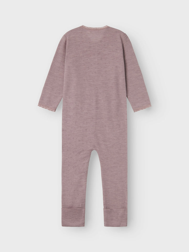 Mysig jumpsuit i ull, merinoull till flicka, tjej som är perfekt som underställ, men även pyjamas när du vill vara säker på att ditt barn håller sig varm och behaglig i både aktivitet och vila. Lägg till mjuka och mysiga ullstilar till ditt barns garderob och säkerställ komfort året runt. Needle drop kännetecknas av tappade stygn för unika mönster och en söt look.

Detaljtyp: sovdräkt
Ärm: Långa ärmar (L/S)
Stängning: Dragkedja
Bendetaljer: Fållar som viks över fötterna för värme
Extra detaljer: Spetsdetalj