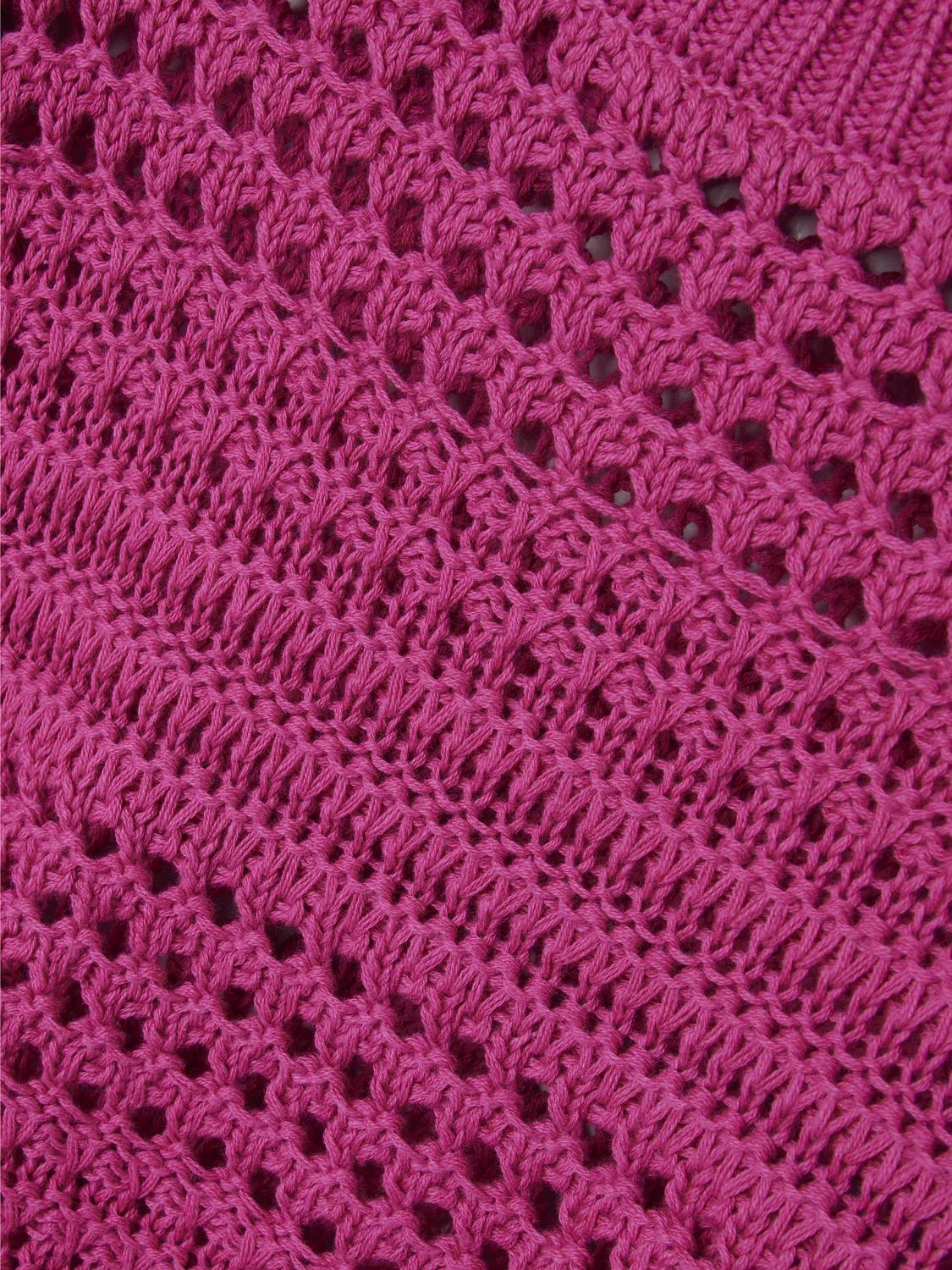 Hålstickad tröja i cerise rosa färg. Närbild av mönstret på en stickad tröja till flicka och ungdom.