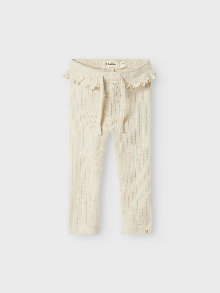 Naturvit baby byxa till lite flicka, tjej. Ekologisk vit bebis byxa i söt modell med volanger.